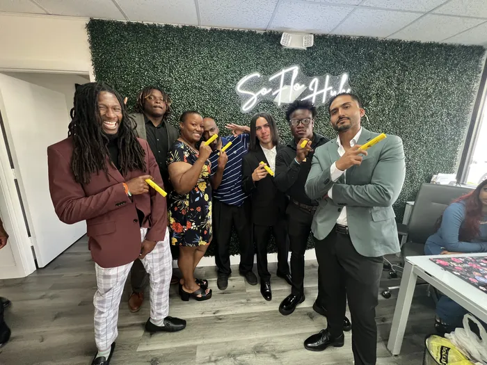 Team members celebrating together at the office hub
